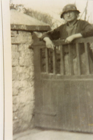 Photograph of Mrs Winifred Skyrme leaning over a gate outside. She lived at Wellhead, Llangwm Pembrokeshire